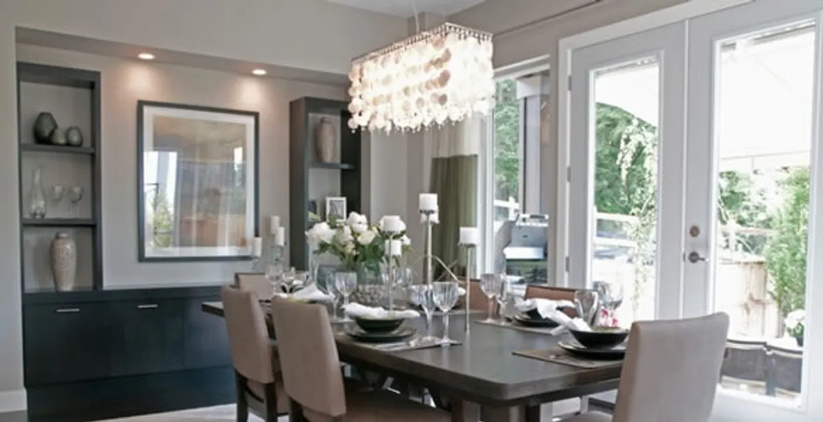 Elegant dining room chandelier installation above table in Long Beach, CA