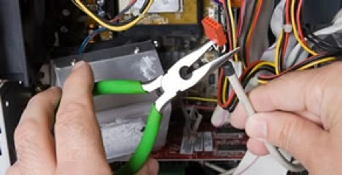 Licensed electrical contractor performing electrical repair with tools in Lomita, CA