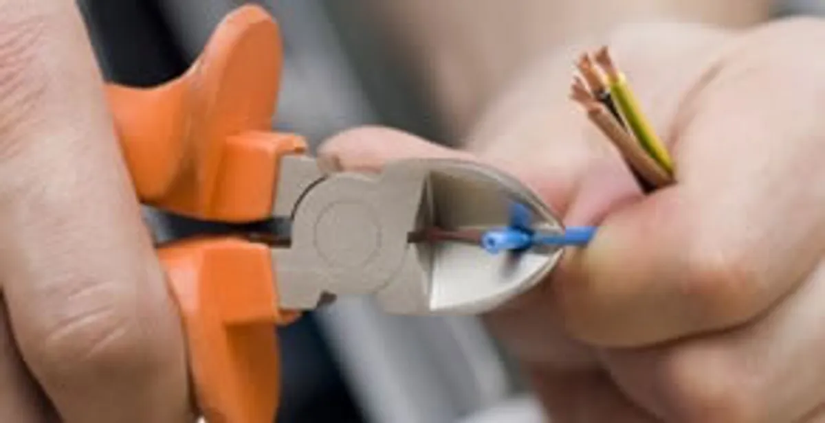 professional electrical services showing precise wire cutting by licensed electricians in Long Beach, CA